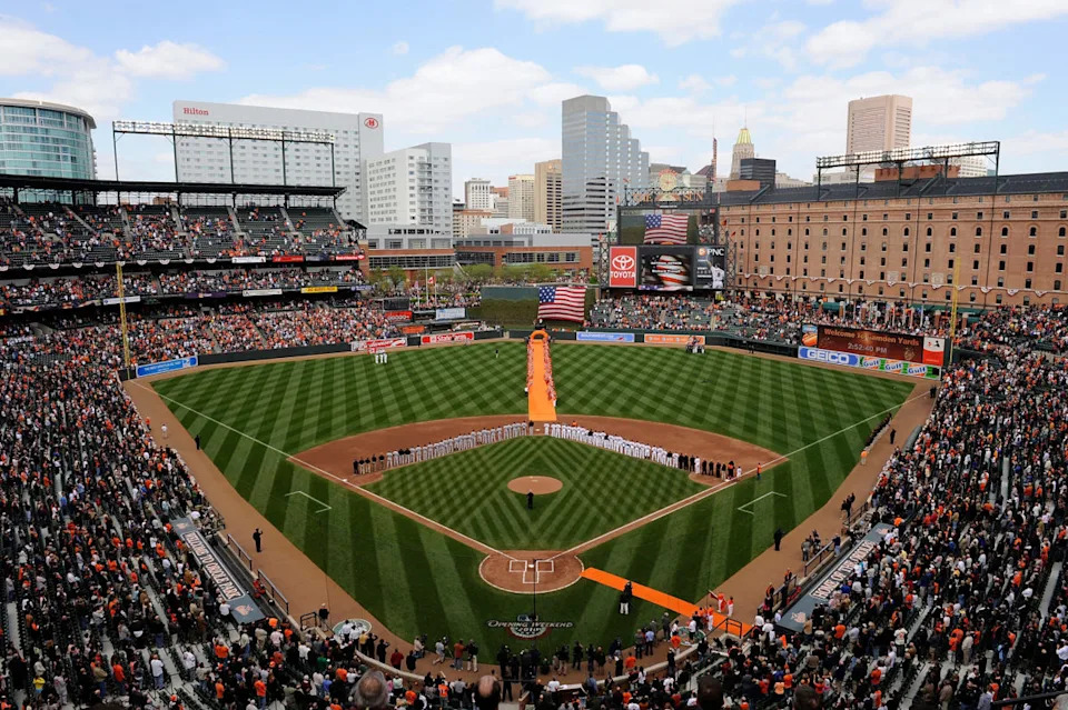 BALTIMORE - APRIL 09: The Baltimore Orioles and the Toronto Blue Jays line up for the National Anthem on Opening Day at Camden Yards on April 9, 2010 in Baltimore, Maryland. (Photo by Greg Fiume/Getty Images)