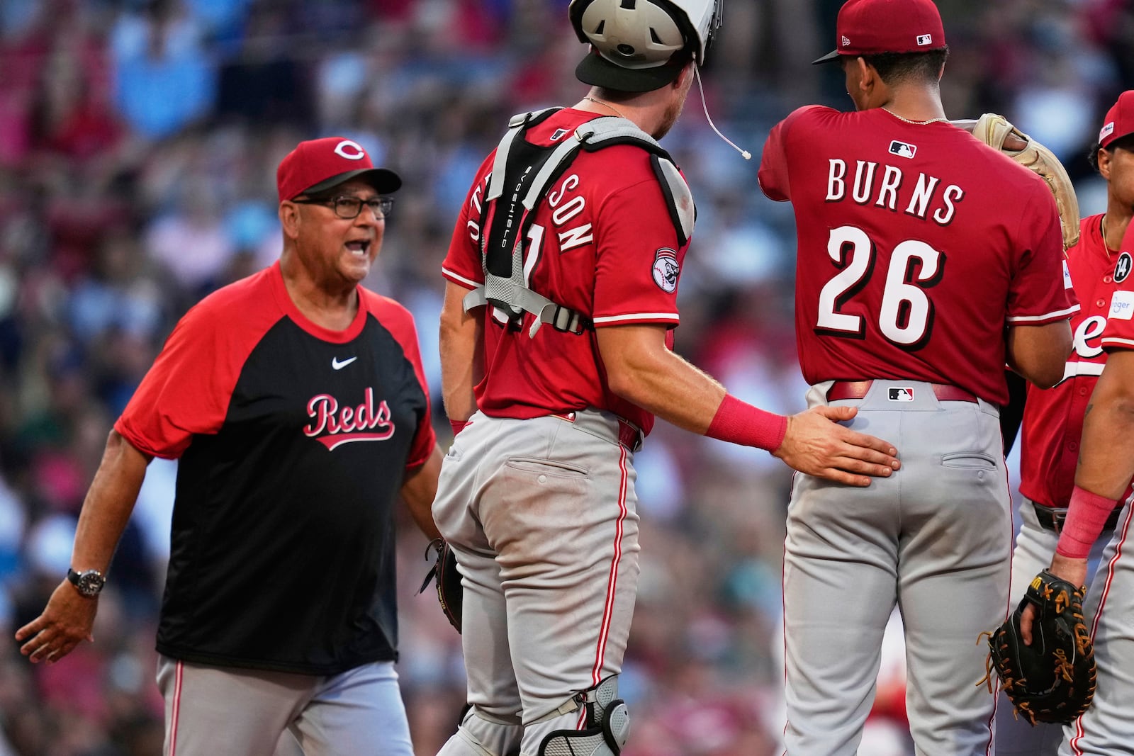 Cincinnati Reds manager Terry Francona, left, pulls pitcher Chase Burns (26) during the first inning of a baseball game against the Boston Red Sox at Fenway Park, Monday, June 30, 2025, in Boston. (AP Photo/Charles Krupa)