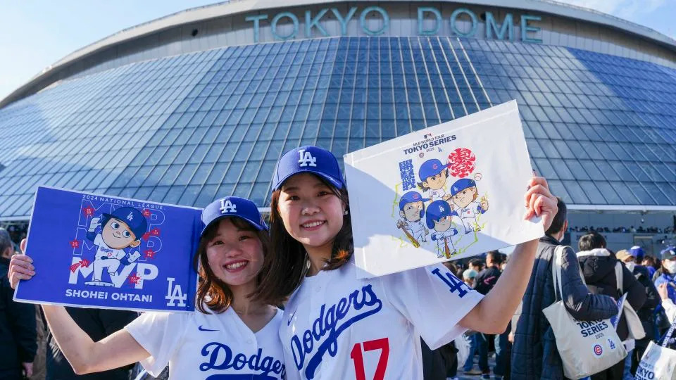 Fans pose for photographs ahead of the baseball game between Los Angeles Dodgers and Chicago Cubs in the MLB Tokyo Series outside of the Tokyo Dome in Tokyo on March 18, 2025. (Photo by Yuichi YAMAZAKI / AFP) / --IMAGE RESTRICTED TO EDITORIAL USE - STRICTLY NO COMMERCIAL USE-- (Photo by YUICHI YAMAZAKI/AFP via Getty Images) - Yuichi Yamazaki/AFP/Getty Images