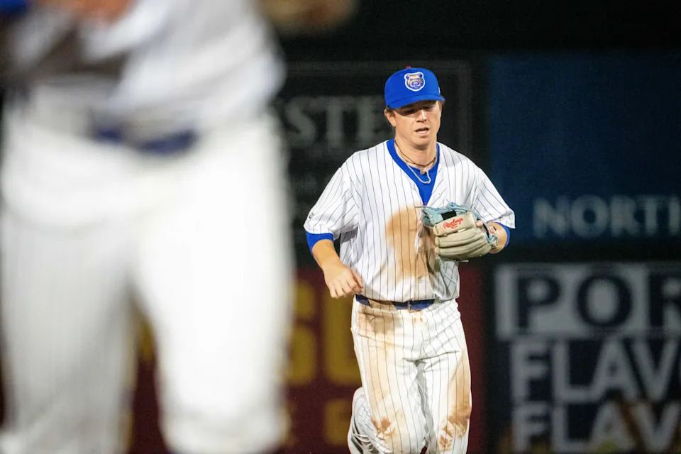 Iowa Cubs' James Triantos (4) returns to the dugout during the season opener against Omaha on Friday, March 28, 2025, at Principal Park in Des Moines.