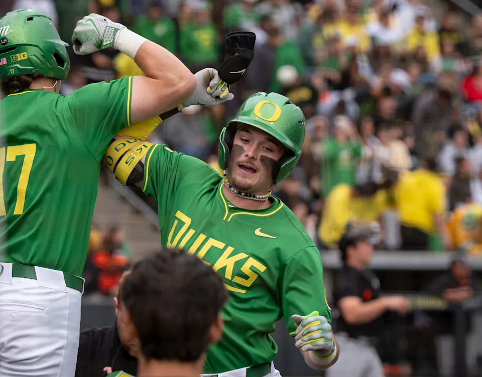 Oregon outfielder Mason Neville, right, celebrates a home run with teammate Drew Smith as the Ducks host Oregon State April 25 at PK Park in Eugene. Neville was the 114th overall pick in the 2025 MLB Draft and was selected by the Cincinnati Reds.