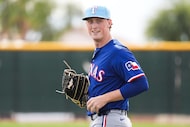 Texas Rangers pitcher Kohl Drake participates in a fielding drill during a spring training...