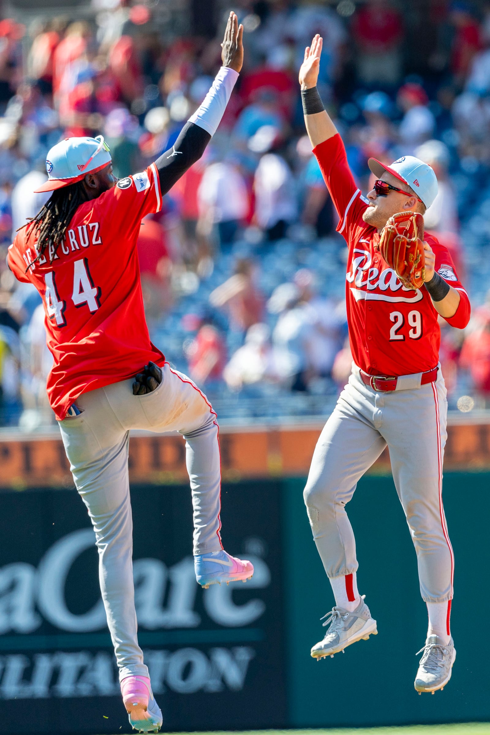 Cincinnati Reds shortstop Elly De La Cruz (44) and center fielder TJ Friedl (29) celebrate after their win over the Philadelphia Phillies in a baseball game, Friday, July 4, 2025, in Philadelphia. (AP Photo/Laurence Kesterson)
