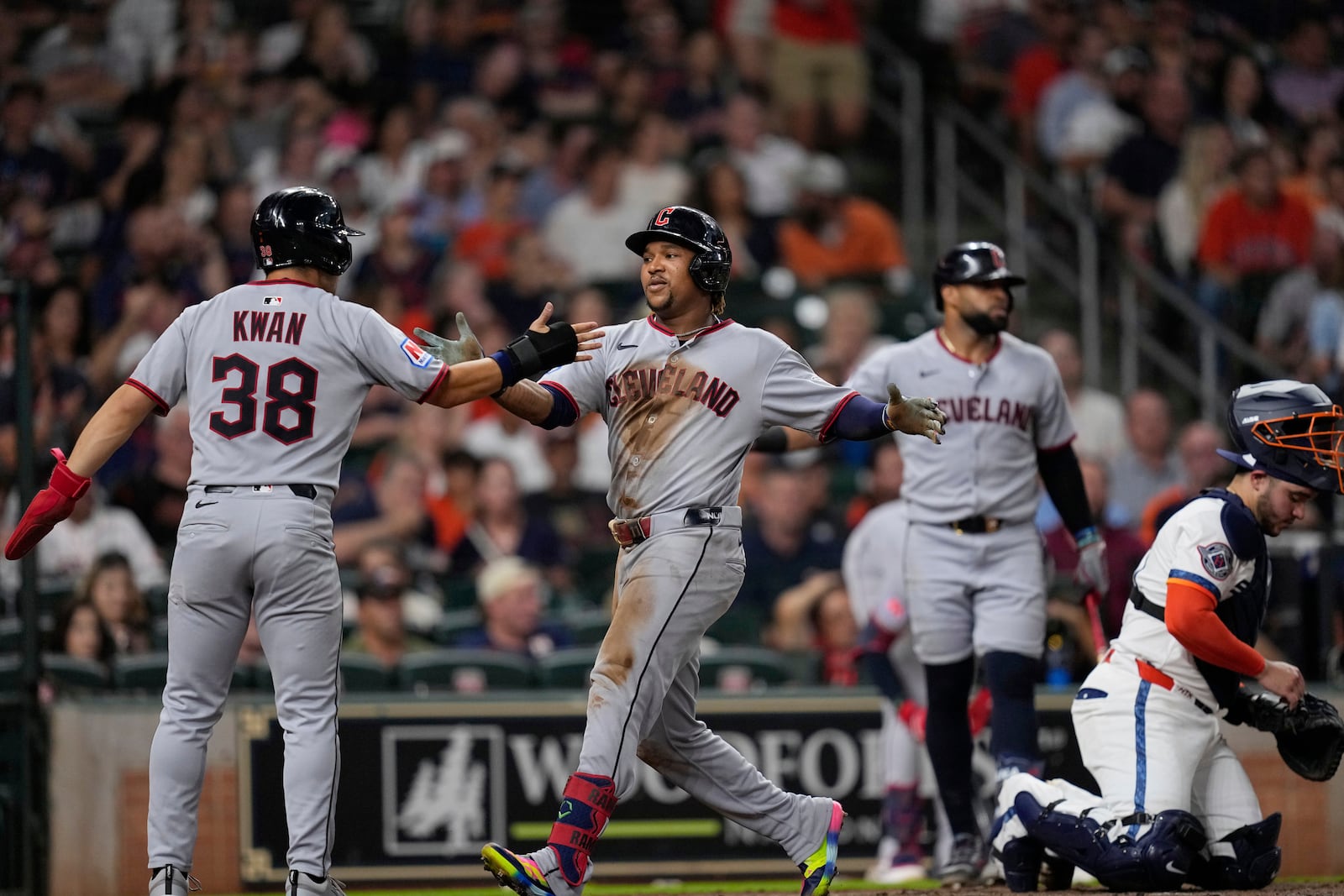 Cleveland Guardians' José Ramírez, center, celebrates with Steven Kwan (38) after both scored on Ramírez's three-run home run against the Houston Astros during the fifth inning of a baseball game Monday, July 7, 2025, in Houston. (AP Photo/David J. Phillip)