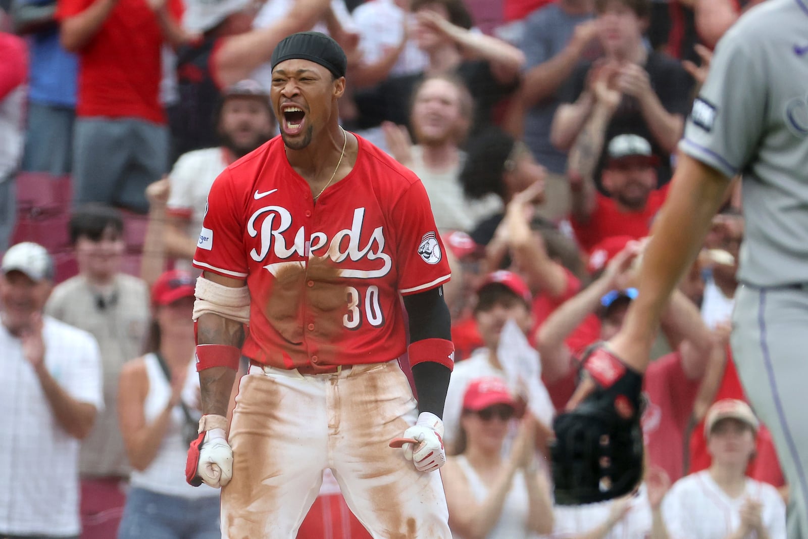 Cincinnati Reds' Will Benson (30) celebrates after hitting an RBI triple during the ninth inning of a baseball game against the Colorado Rockies, Saturday, July 12, 2025, in Cincinnati. (AP Photo/Joe Maiorana)