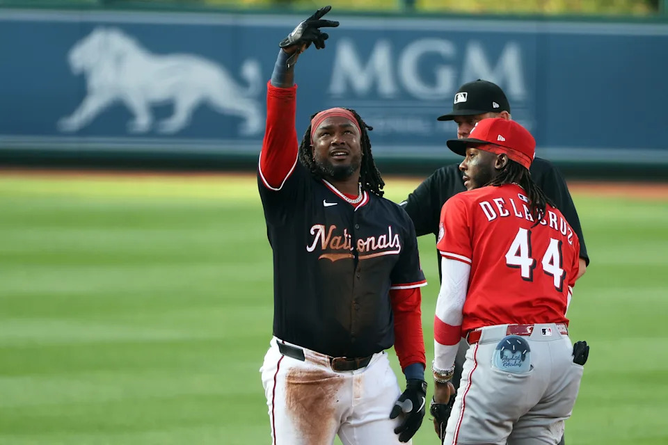 Josh Bell celebrates his double during the Nationals' four-run first inning against Reds starter Brady Singer.