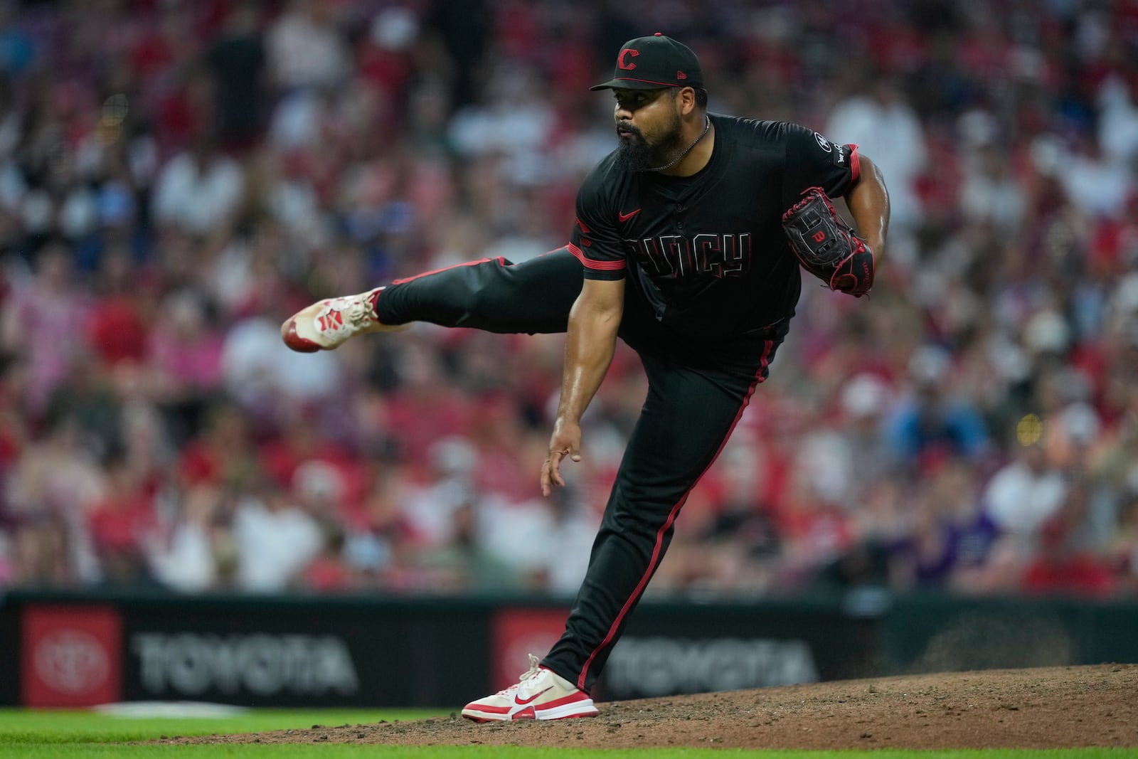Cincinnati Reds pitcher Tony Santillan throws during the eighth inning of a baseball game against the Colorado Rockies in Cincinnati, Friday, July 11, 2025. (AP Photo/Carolyn Kaster)