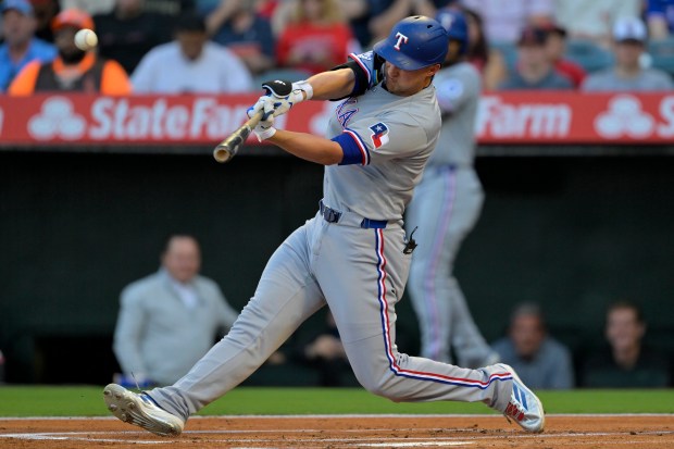 The Texas Rangers’ Corey Seager hits a two-run home run...
