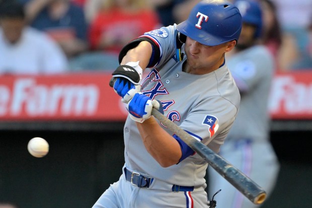 The Texas Rangers’ Corey Seager hits a two-run home run...