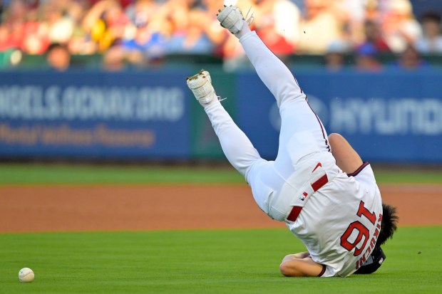 Angels starting pitcher Yusei Kikuchi loses his glove and flips...