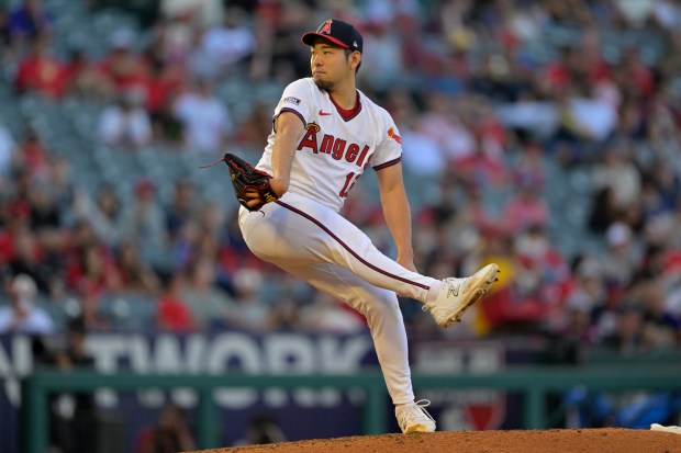 Angels starting pitcher Yusei Kikuchi throws to the plate during...