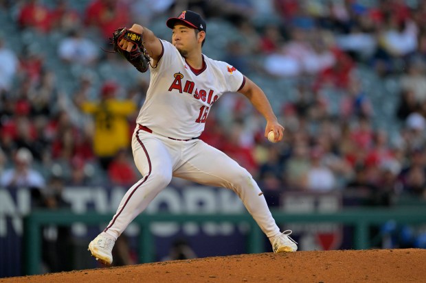 Angels starting pitcher Yusei Kikuchi throws to the plate during...