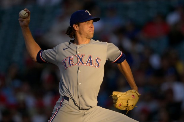 Texas Rangers starting pitcher Jacob deGrom throws to the plate...