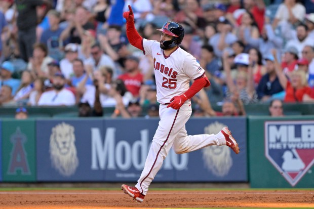 The Angels’ Travis d’Arnaud rounds the bases after hitting a...