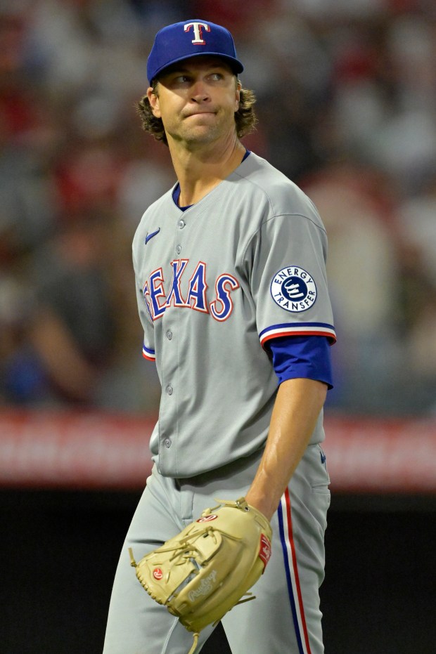 Texas Rangers starting pitcher Jacob deGrom walks off the mound...