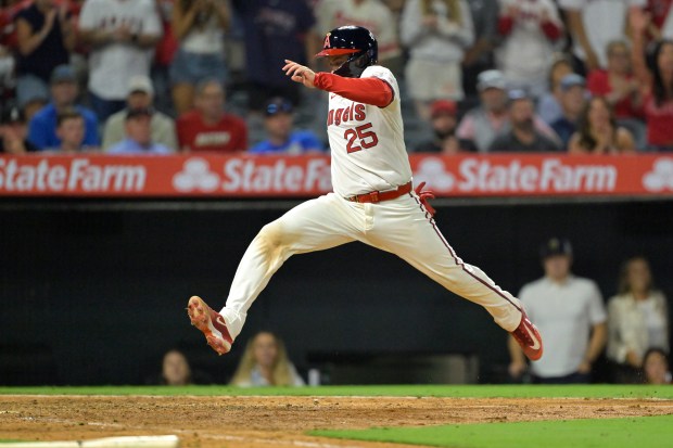 The Angels’ Travis d’Arnaud scores the go-ahead run on a...