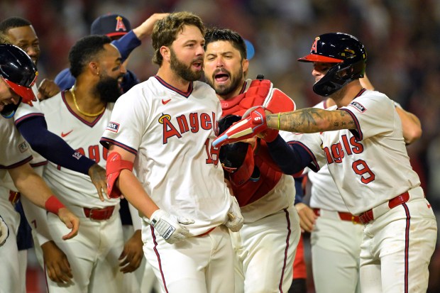 The Angels’ Nolan Schanuel, center, celebrates with teammates after working...