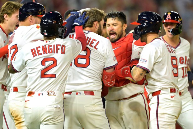 The Angels’ Nolan Schanuel (18) celebrates with teammates after working...