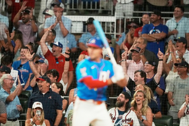 Fans watch the Atlanta Braves’ Matt Olson compete during the...