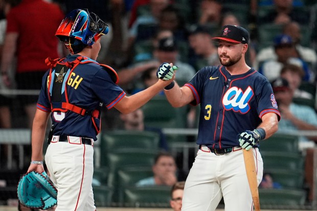 The Seattle Mariners’ Cal Raleigh greets his brother Todd Jr....