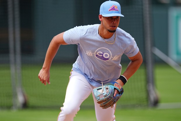 Colorado Rockies shortstop Ezequiel Tovar warms up before a baseball game against the Minnesota Twins, Friday, July 18, 2025, in Denver. (AP Photo/David Zalubowski)