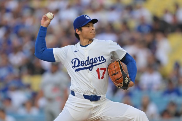 Dodgers starting pitcher Shohei Ohtani throws to the plate during...