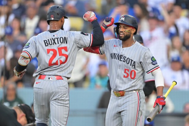 The Minnesota Twins’ Byron Buxton, left, is congratulated by teammate...
