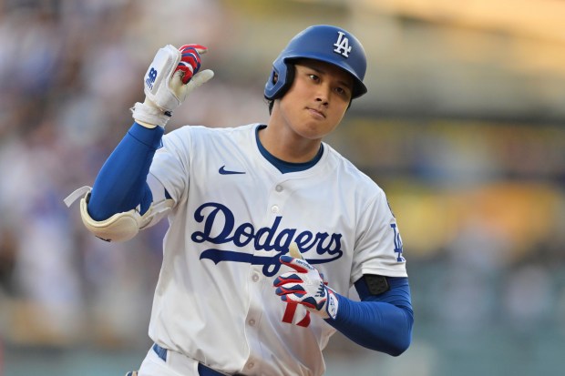 Dodgers star Shohei Ohtani gestures as he runs the bases...