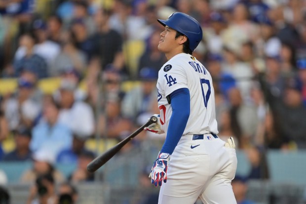 Dodgers star Shohei Ohtani watches the flight of his two-run...