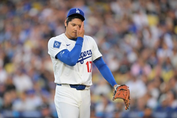 Dodgers starting pitcher Shohei Ohtani walks to the dugout after...