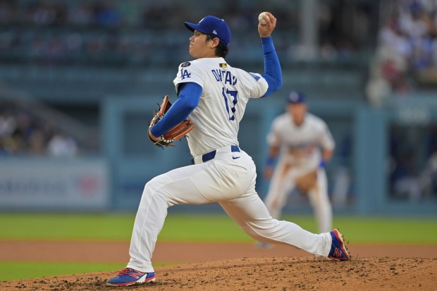 Dodgers starting pitcher Shohei Ohtani throws to the plate during...