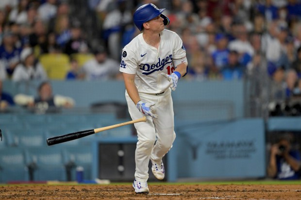 The Dodgers’ Will Smith watches the flight of his solo...