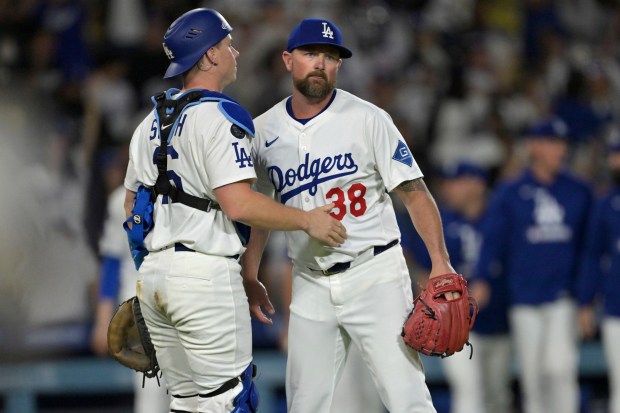 Dodgers catcher Will Smith, left, congratulates relief pitcher Kirby Yates...