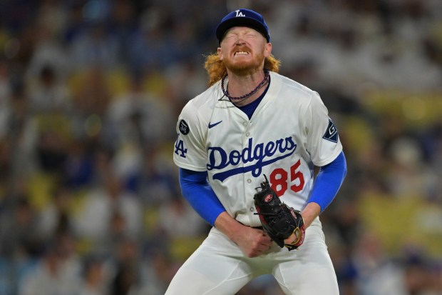 Dodgers pitcher Dustin May reacts after giving up a single...