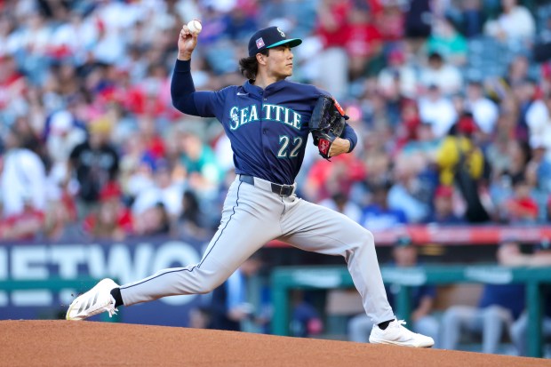 Seattle Mariners starting pitcher Bryan Woo throws to the plate...
