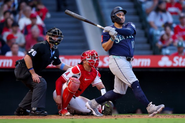The Seattle Mariners’ Josh Naylor follows through on a swing...
