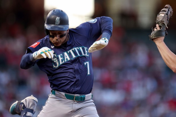 Seattle Mariners designated hitter Jorge Polanco is tagged out at...