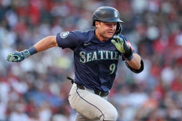 The Seattle Mariners’ Ben Williamson runs to first base during...
