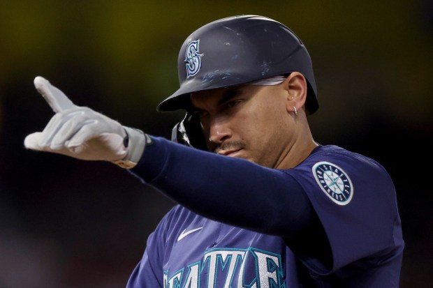 The Seattle Mariners’ Josh Naylor gestures from first base after...