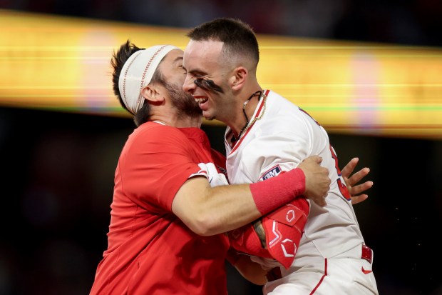 The Angels’ Zach Neto, right, celebrates with teammate Travis d’Arnaud...