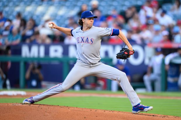 Texas Rangers starting pitcher Jacob deGrom throws to the plate...