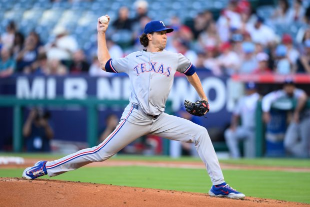 Texas Rangers starting pitcher Jacob deGrom throws to the plate...