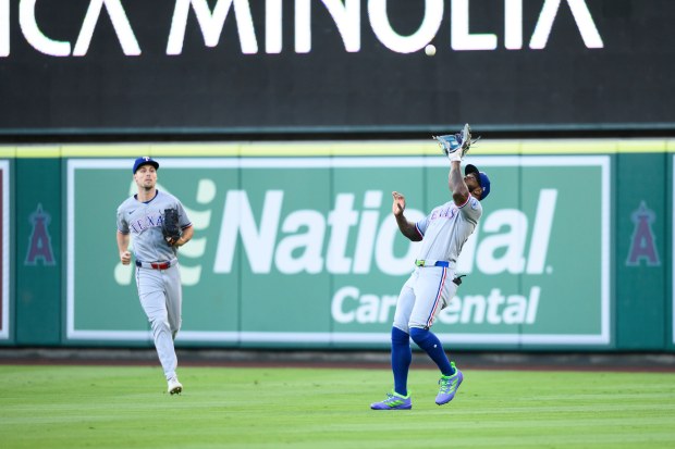 Texas Rangers right fielder Adolis García makes a catch during...