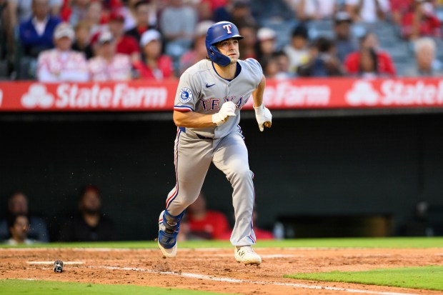 The Texas Rangers’ Josh Smith runs after hitting a triple...