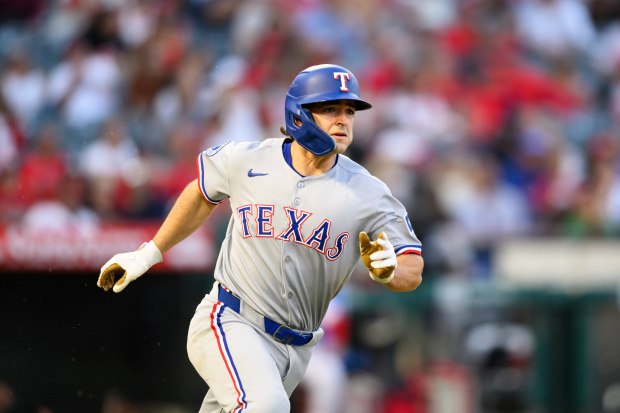 The Texas Rangers’ Josh Smith runs after hitting a triple...