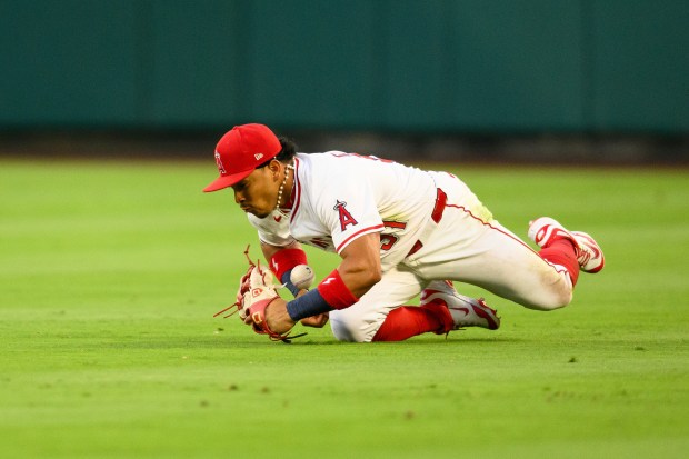 Angels right fielder Gustavo Campero makes an error while trying...