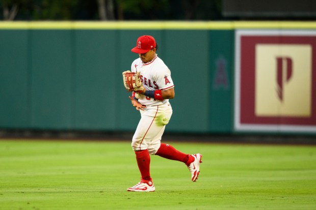 Angels right fielder Gustavo Campero makes an error while trying...