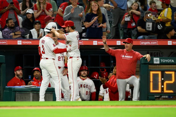The Angels’ Taylor Ward, left, is greeted by teammate Nolan...