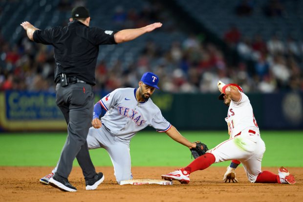 The Angels’ Gustavo Campero, right, safely steals second base during...