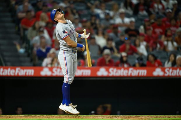 The Texas Rangers’ Josh Jung reacts after striking out during...